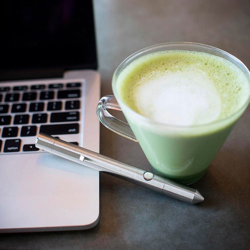Linx Ares Dab Straw Laid On Side of Laptop, Next To Cup of Green Colored Tea 